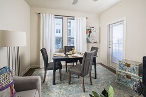 San Antonio apartment for rent - A dining room with a table set for two and a couch.