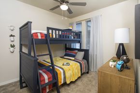 San Antonio apartment for rent - A bedroom with a bunk bed and a ceiling fan.