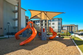 San Antonio apartment for rent - A playground with a yellow canopy and orange slides.