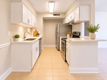 Tampa apartment for rent - A kitchen with white cabinets and appliances.