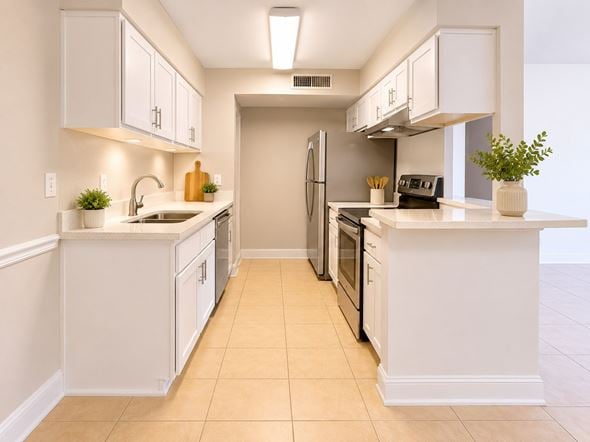 Tampa apartment for rent - A kitchen with white cabinets and appliances.