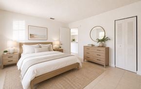 Tampa apartment for rent - A bedroom with a large bed, two nightstands, and a dresser.