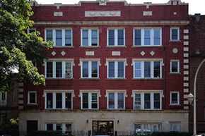 Chicago apartment for rent - a red brick building with many windows on it