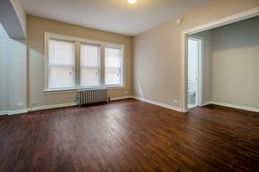 Chicago apartment for rent - the living room of an empty house with wood floors