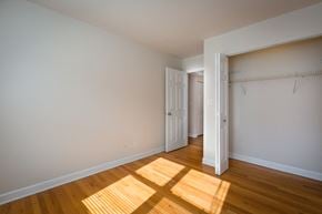 Chicago apartment for rent - a bedroom with wood floors and white walls and a closet