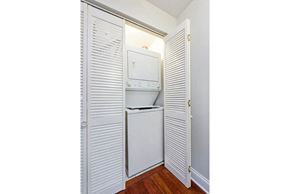 Chicago apartment for rent - a small laundry room with a washer and dryer in it