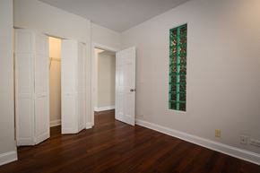 Chicago apartment for rent - a living room with wood floors and a green glass window