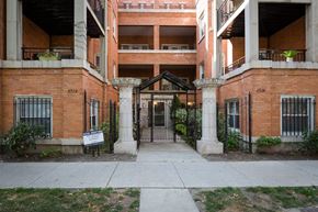 Chicago apartment for rent - the entrance to an apartment building with a sidewalk and a gate
