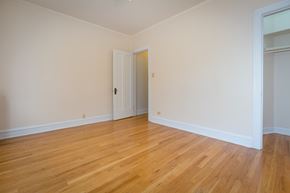 Chicago apartment for rent - a empty living room with wood floors and white walls