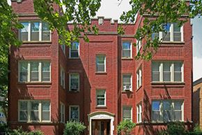 Chicago apartment for rent - a red brick building with trees in front of it