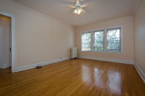 Chicago apartment for rent - a living room with wood floors and a ceiling fan
