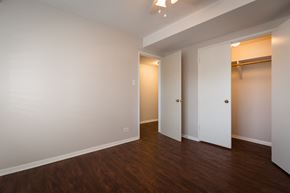 Chicago apartment for rent - a bedroom with white walls and wood flooring and a closet