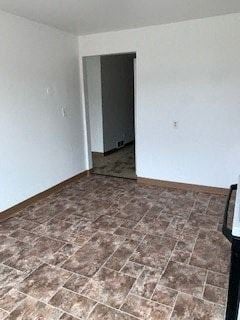 Glassport apartment for rent - A room with a brown tile floor and a black door.