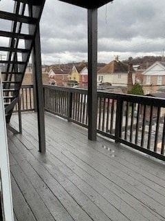 Glassport apartment for rent - A wooden deck with a metal railing and a staircase.