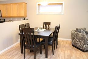 Brandon condo for rent - a dining room with a wooden table and chairs