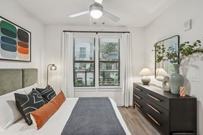 Nashville apartment for rent - A bedroom with a bed, dresser, and window with blinds.