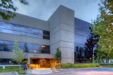 Boise apartment for rent - a large building with glass windows at night