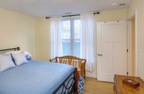 Northampton apartment for rent - a bedroom with a bed and a window with white curtains