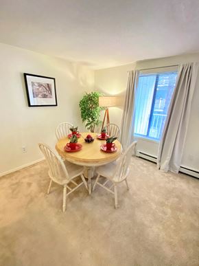 New Britain apartment for rent - a dining room with a table and chairs and a window