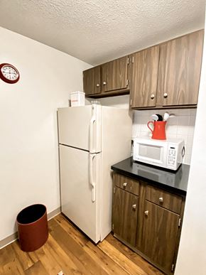 New Britain apartment for rent - a kitchen with a refrigerator and a microwave and cabinets