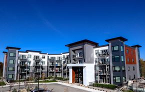 Winnipeg apartment for rent - an exterior view of an apartment complex with a blue sky