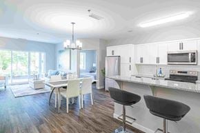 Winnipeg apartment for rent - an open kitchen and dining room with a table and chairs