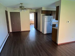 Oak Forest apartment for rent - A kitchen with a white fridge and wooden floors.