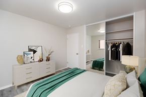 Oakland apartment for rent - A bedroom with a large bed and a wardrobe.