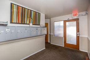 Oakland apartment for rent - A hallway with a red exit sign above the door.