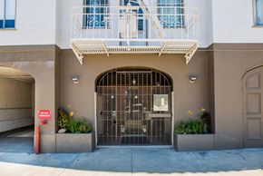 Oakland apartment for rent - A building with a balcony and a gate.