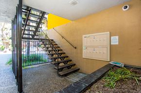 Oakland apartment for rent - A staircase with a yellow triangle on the wall.