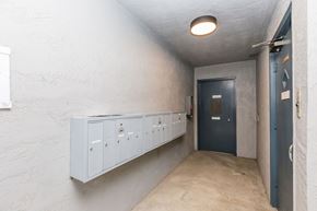 Oakland apartment for rent - A hallway with a blue door and white walls.