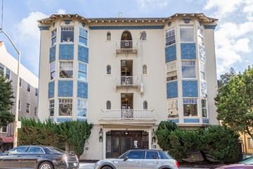 Oakland apartment for rent - A white building with blue trim and a balcony.