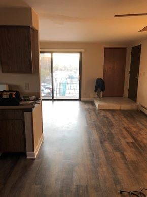 Oak Forest apartment for rent - an empty living room with wooden floors and a door to a balcony