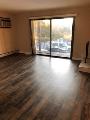 Oak Forest apartment for rent - an empty living room with wood floors and a sliding glass door