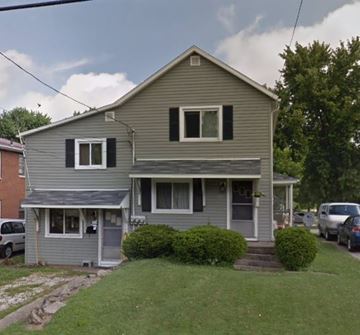 Wadsworth apartment for rent - A two-story house with a gray exterior and a covered porch.