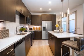 Westminster apartment for rent - a kitchen with wooden cabinets and white counter tops and stainless steel appliances