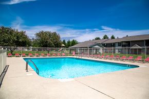 Anderson apartment for rent - our resort style swimming pool is in front of our house with red chairs
