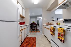 Anderson apartment for rent - a kitchen with white cabinets and white appliances and a white refrigerator