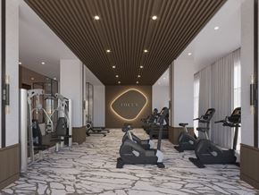 Laval apartment for rent - A gym with a variety of equipment including treadmills, stationary bikes, and weight machines.