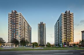 Laval apartment for rent - Three modern high-rise buildings are shown in the image.