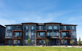 Edmonton townhouse for rent - a large apartment building with balconies on a sunny day