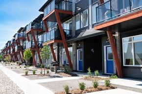 Edmonton townhouse for rent - a row of houses with balconies and a sidewalk