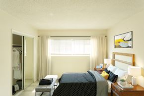 Los Angeles apartment for rent - Bright white bedroom with large window and sliding mirror over closet