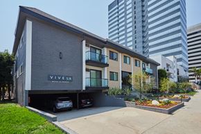 Los Angeles apartment for rent - Exterior with cars in garage, plants out front, and balconies