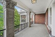 Kansas City apartment for rent - a long balcony with a brick building and a large window