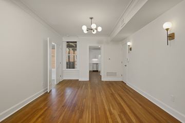Kansas City apartment for rent - a living room with wood floors and white walls and a large window