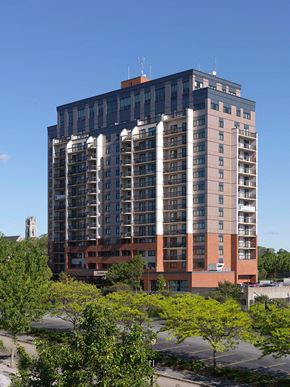 New Bedford apartment for rent - a tall building with trees in front of it