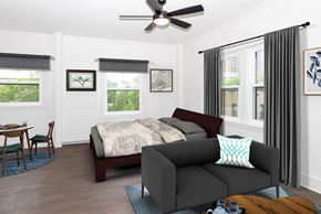 Minneapolis apartment for rent - A bedroom with a bed, a couch, and a dining table.