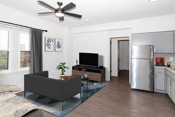 Minneapolis apartment for rent - A living room with a grey couch and a television.